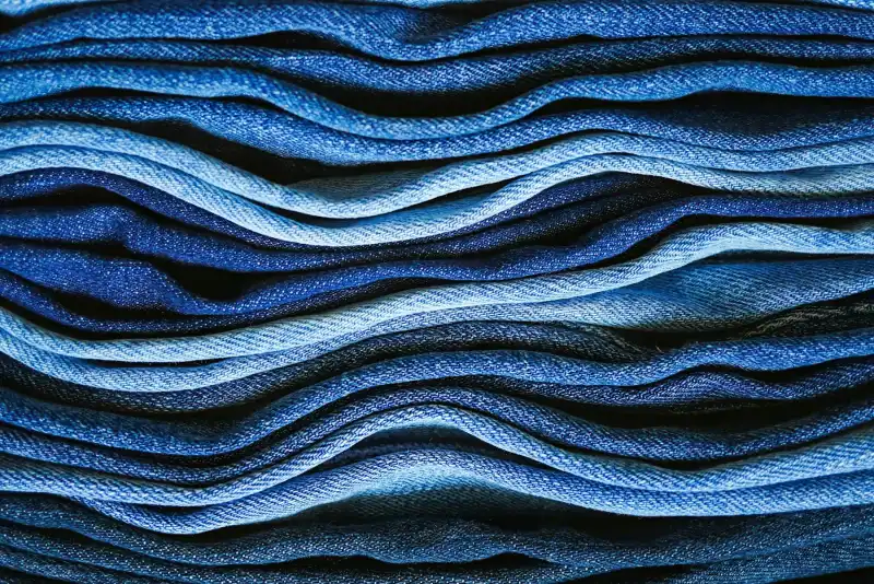 Folded denim fabric, close-up (illustrative photo)