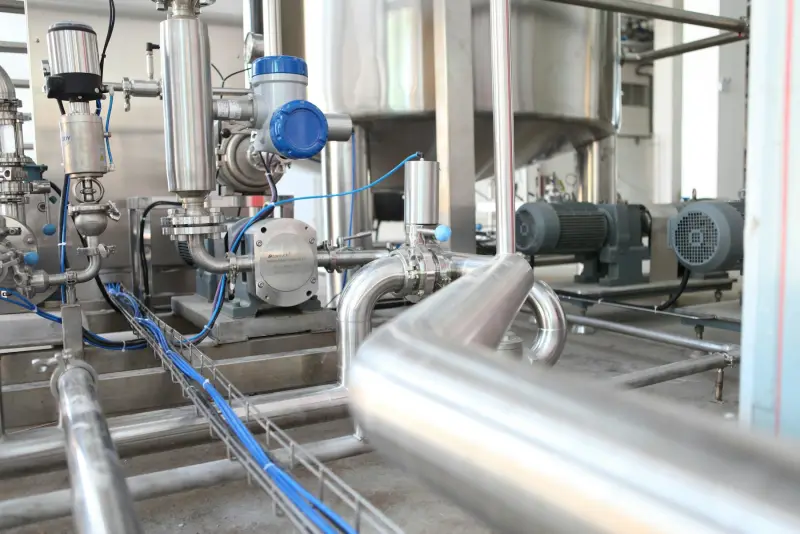 Stainless-steel pumps and valves on an industrial process line (illustrative photo)
